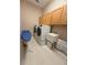 Bright laundry room featuring modern washer and dryer, storage cabinets, and folding station at 4906 Keaton Crest Dr, Orlando, FL 32837