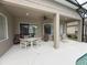 Relaxing covered patio with ceiling fan and ample seating area by windows at 4906 Keaton Crest Dr, Orlando, FL 32837