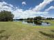 Beautiful view of community pond with lush green grass surrounding it at 4906 Keaton Crest Dr, Orlando, FL 32837