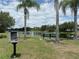 Scenic view of a neighborhood pond with a little free library and bench seating at 4906 Keaton Crest Dr, Orlando, FL 32837