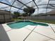 Refreshing backyard pool featuring a screened enclosure and lush landscaping at 4906 Keaton Crest Dr, Orlando, FL 32837