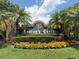 A community sign for Keaton's Crest, surrounded by lush landscaping and vibrant flowers at 4906 Keaton Crest Dr, Orlando, FL 32837