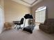 This home's versatile room includes a treadmill, keyboard, chair, and plenty of space at 4906 Keaton Crest Dr, Orlando, FL 32837