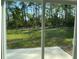 Sliding glass doors open to a spacious backyard with lush green lawn and plenty of privacy at 5153 Sw 159Th St, Ocala, FL 34473