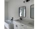 Stylish bathroom featuring a soaking tub, double sinks, and modern black fixtures at 5153 Sw 159Th St, Ocala, FL 34473