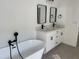 Elegant bathroom with a soaking tub, double vanity, and modern fixtures at 5153 Sw 159Th St, Ocala, FL 34473