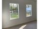Sunlit bedroom with large windows offering scenic outdoor views at 5153 Sw 159Th St, Ocala, FL 34473