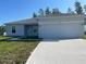 Charming single-story home with a two-car garage and well-manicured lawn at 5153 Sw 159Th St, Ocala, FL 34473