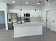 Bright kitchen with white cabinets, stainless appliances, and a center island at 5153 Sw 159Th St, Ocala, FL 34473
