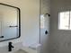 Contemporary bathroom featuring a glass-enclosed shower with modern fixtures and tiled walls at 5153 Sw 159Th St, Ocala, FL 34473