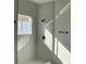 Modern shower with glass enclosure and white tile at 5153 Sw 159Th St, Ocala, FL 34473
