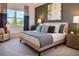 Bedroom showcases a luxurious bed with decorative pillows, stylish lamps, and a calming ambiance enhanced by a large window at 519 Silver Palm Dr, Haines City, FL 33844
