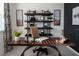 Home office featuring a spacious wooden desk, stylish shelving, and decor, creating an inspiring and functional workspace at 519 Silver Palm Dr, Haines City, FL 33844