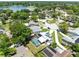 Aerial view of a neighborhood with a home featuring a screened-in pool and solar panels at 525 Southport Dr, Longwood, FL 32750