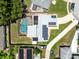 Aerial view of a property with a screened-in pool and solar panels on the roof at 525 Southport Dr, Longwood, FL 32750