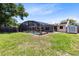 Spacious backyard with a screened-in pool, shed, and lush green lawn at 525 Southport Dr, Longwood, FL 32750