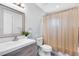 Neutral bathroom with a single sink vanity, toilet and shower with shower curtain at 525 Southport Dr, Longwood, FL 32750