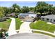 Charming home featuring solar panels, a well-maintained lawn, and a long driveway at 525 Southport Dr, Longwood, FL 32750