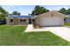 Charming single-story home with solar panels, a well-maintained lawn, and an attached two-car garage at 525 Southport Dr, Longwood, FL 32750