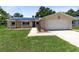 Charming single-story home with a well-maintained lawn and solar panels on the roof at 525 Southport Dr, Longwood, FL 32750