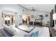 Bright living room with vaulted ceilings, ceiling fan, luxury vinyl flooring, and a modern aesthetic at 525 Southport Dr, Longwood, FL 32750