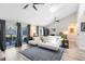 Spacious living room with vaulted ceilings, ceiling fan, luxury vinyl flooring, and sliding door access to a patio at 525 Southport Dr, Longwood, FL 32750