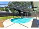 Bright screened-in pool area with a spa and a fountain feature surrounded by a wooden fence at 525 Southport Dr, Longwood, FL 32750