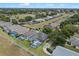 An aerial view of a single-Gathering home showcases the screened-in pool and well-manicured lawn at 548 Casterton Cir, Davenport, FL 33897