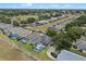 An aerial view of a single-Gathering home showcases the screened-in pool and well-manicured lawn at 548 Casterton Cir, Davenport, FL 33897