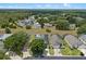 An aerial view of the home in a well-maintained community, showing lush landscaping and nearby wooded areas at 548 Casterton Cir, Davenport, FL 33897