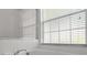 Close-up on the soaking tub with tile surround, chrome faucet, and view of the glass shower at 548 Casterton Cir, Davenport, FL 33897