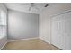 Bedroom features a tile floor, a ceiling fan and a large closet at 548 Casterton Cir, Davenport, FL 33897