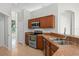 Kitchen with stainless steel appliances, wood cabinets, tile floor and solid surface countertops at 548 Casterton Cir, Davenport, FL 33897