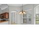 Kitchen featuring a chandelier, natural light, and an arched doorway at 548 Casterton Cir, Davenport, FL 33897