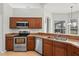 Kitchen with stainless steel appliances, solid surface countertops and wood cabinets at 548 Casterton Cir, Davenport, FL 33897
