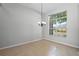 Bright living room featuring tile floors, high ceilings, a chandelier and a large window offering exterior views at 548 Casterton Cir, Davenport, FL 33897