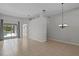 Neutral living room featuring tile floors, recessed lighting, sliding glass doors, and an adjacent dining area at 548 Casterton Cir, Davenport, FL 33897