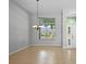 Bright living room featuring tile floors, high ceilings, a chandelier and a large window offering exterior views at 548 Casterton Cir, Davenport, FL 33897