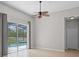Bright main bedroom featuring tile floors, sliding glass doors to the pool, and an ensuite bathroom at 548 Casterton Cir, Davenport, FL 33897