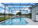 Inviting in-ground pool surrounded by a screen enclosure and a well-maintained patio at 548 Casterton Cir, Davenport, FL 33897