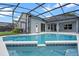 A stunning screened-in pool with a refreshing blue hue, tiled accents, and a spacious deck, perfect for outdoor relaxation at 548 Casterton Cir, Davenport, FL 33897