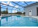Beautiful in-ground pool enclosed with a screen and featuring a clear blue water at 548 Casterton Cir, Davenport, FL 33897