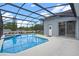 Beautiful in-ground pool enclosed with a screen and featuring a clear blue water at 548 Casterton Cir, Davenport, FL 33897