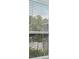 An eye-level view of foliage from a window with horizontal blinds at 548 Casterton Cir, Davenport, FL 33897