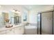 Bright bathroom with soaking tub, glass enclosed shower and marble countertops at 5652 Nevis Ter, Kissimmee, FL 34758