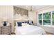 Cozy bedroom featuring a large window, accent wall, and stylish furnishings, creating a relaxing retreat at 5652 Nevis Ter, Kissimmee, FL 34758
