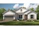 Charming single-story home with stone accents, neutral colors, and a well-manicured lawn, perfect for curb appeal at 5652 Nevis Ter, Kissimmee, FL 34758