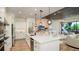 Modern kitchen with large island, stainless steel appliances and adjacent living area at 5652 Nevis Ter, Kissimmee, FL 34758
