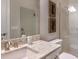 Modern bathroom features granite countertop, framed mirror, and walk-in shower with glass door at 5658 Nevis Ter, Kissimmee, FL 34758
