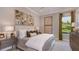 Comfortable bedroom with neutral tones, golf course view, and ample natural light at 5658 Nevis Ter, Kissimmee, FL 34758